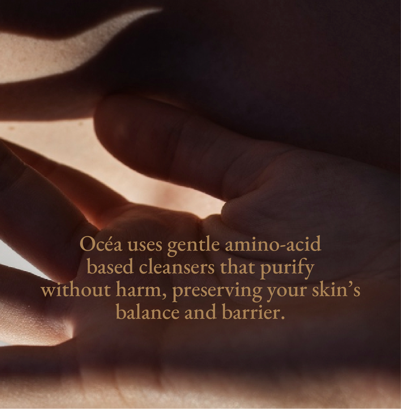 Close-up of hands with a text overlay about moisturing realaxing body wash Ocea that uses gentle amino-acid preserving skin balance and barrier.